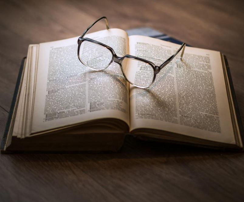 picture of a book with glasses on it