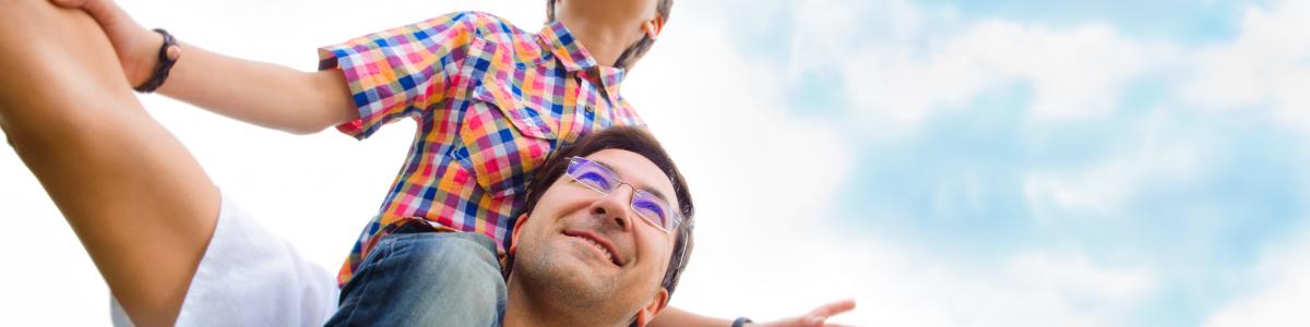 dad with son on shoulders